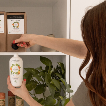 woman dispensing product into bottle