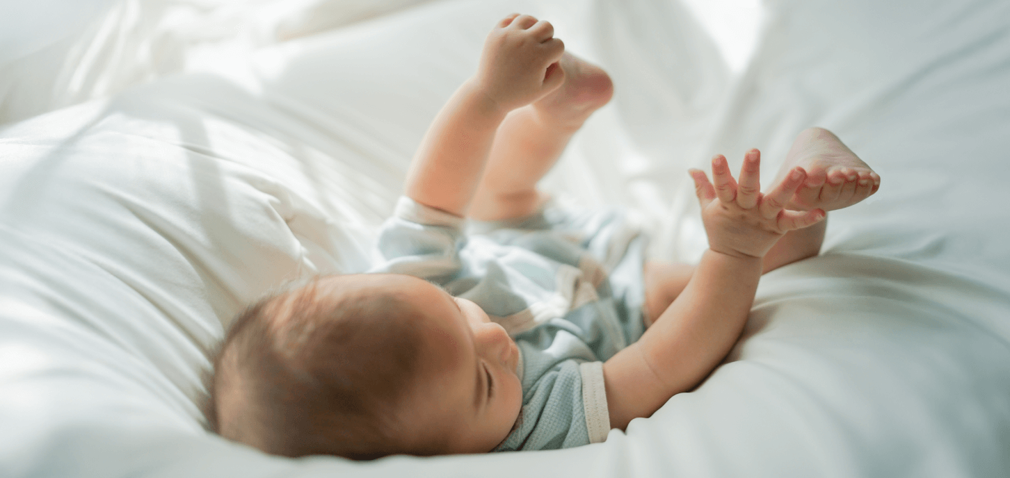baby lying down laughing