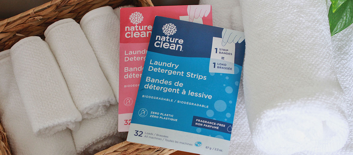Nature Clean products in a laundry basket with white towels
