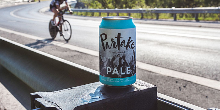 pale ale can with cyclist in background